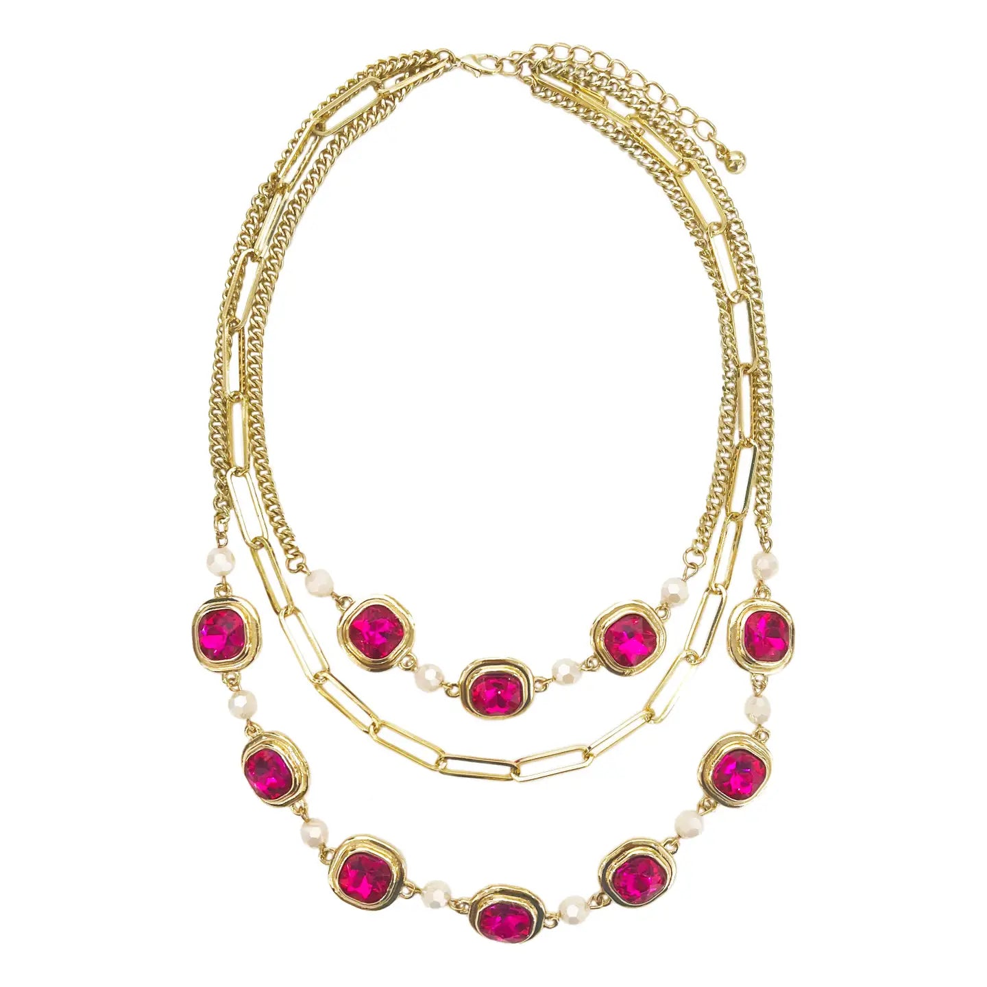 Gold three-strand necklace featuring a mix of chain styles—paperclip and curb—adorned with vibrant hot pink gemstones and pearl-like beads, displayed on a white background.