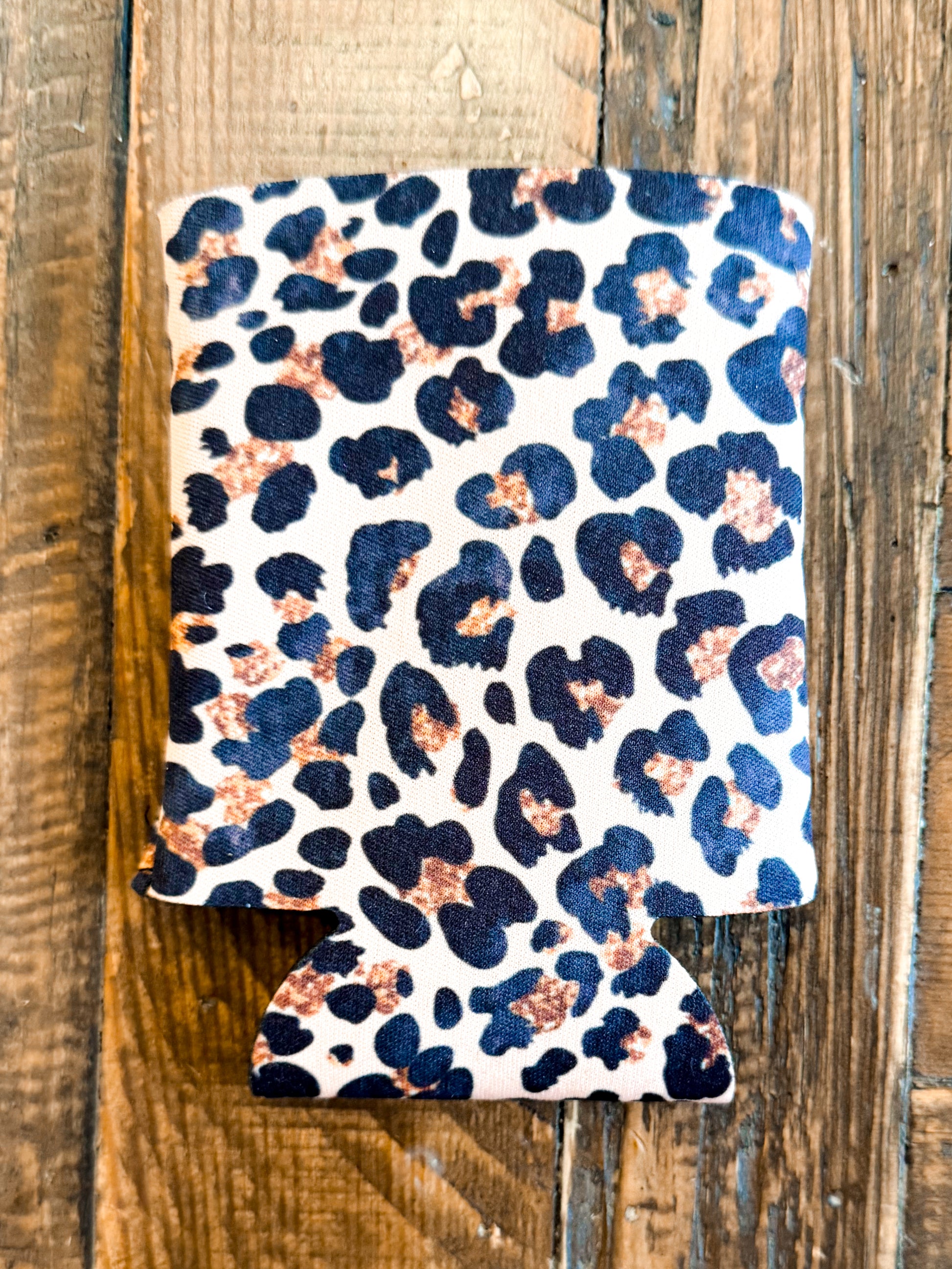 Can cooler featuring a white background with classic black and rust-toned leopard spots, perfect for a sleek and wild vibe.
