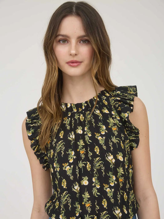 Women's sleeveless black woven blouse with yellow and white floral print, round neckline, ruffle sleeve detail, and back keyhole eye closure made from rayon-blend fabric
