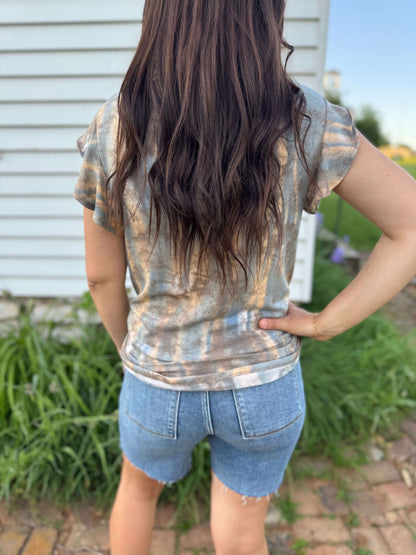 Rear view of the blouse displaying the seamless pattern and ruffle details extending to the back.