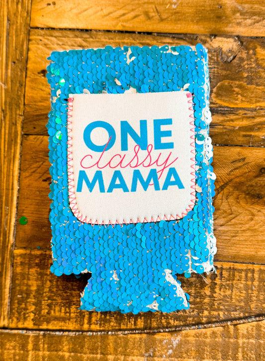 Blue sequin slim can cooler with a white patch that reads “One Classy Mama” in bold blue and cursive pink lettering.